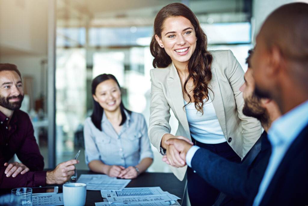 Cropped shot of two business people shaking hands during a meeting in the boardroom